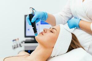 Face Skin Care. Close-up Of Woman Getting Facial Hydro Microdermabrasion Peeling Treatment At Cosmetic Beauty Spa Clinic. Hydra Vacuum Cleaner. Exfoliation, Rejuvenation And Hydratation. Cosmetology. photo