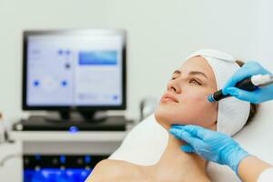 Face Skin Care. Close-up Of Woman Getting Facial Hydro Microdermabrasion Peeling Treatment At Cosmetic Beauty Spa Clinic. Hydra Vacuum Cleaner. Exfoliation, Rejuvenation And Hydratation. Cosmetology. photo