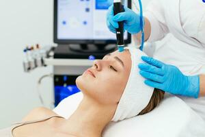 Face Skin Care. Close-up Of Woman Getting Facial Hydro Microdermabrasion Peeling Treatment At Cosmetic Beauty Spa Clinic. Hydra Vacuum Cleaner. Exfoliation, Rejuvenation And Hydratation. Cosmetology. photo