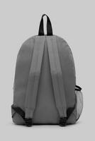 close up blank backpack with zipper and shoulder straps isolated on white background. travel day pack rucksack. folding nylon school backpack. top view. mock up. photo