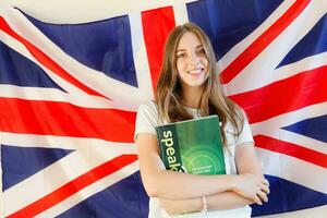 Young woman with flags of English speaking countries photo