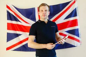 Portrait of young man against British flag photo