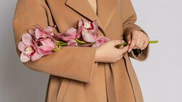 Seductive blonde woman in brown jacket posing in studio photo