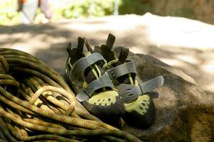 Hiking boots and rope on campfire background. Lifestyle travel relationship. photo