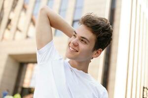 Handsome young hipster stylish man in white shirt, black pants photo