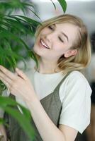 Close up young cheerful woman in dress happily looking in camera photo