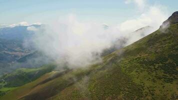 A majestic mountain peak enveloped in fluffy clouds video