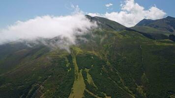 Snow-capped mountain range covered in clouds video