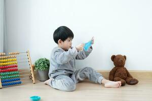 Asian boy having fun playing slam on the floor Learning outside the classroom photo