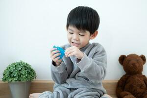 Asian boy having fun playing slam on the floor Learning outside the classroom photo