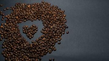 heap of coffee beans on black background photo