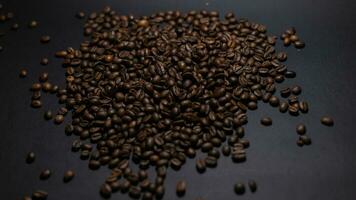 heap of coffee beans on black background photo