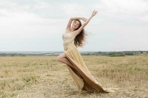 woman walking in golden dried grass field. photo