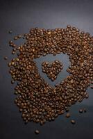 heap of coffee beans on black background photo