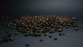 heap of coffee beans on black background photo