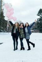 Young beautiful cheerful female friend in colorful jackets having fun photo