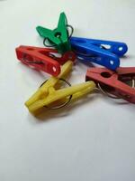 Colored plastic clothespins on white background Macro Space design element for text photo