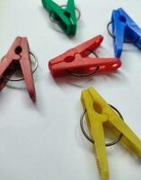 Colored plastic clothespins on white background Macro Space design element for text photo