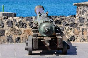 Antique cannon at the wall photo