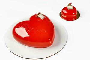 Mousse cake and pastry in shape of hearts with glossy red glaze photo