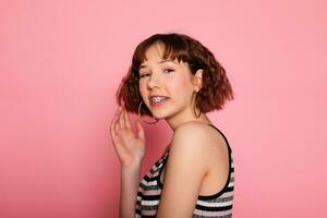 Image of young happy beautiful woman posing isolated over pink photo