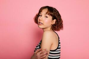 Image of young happy beautiful woman posing isolated over pink photo