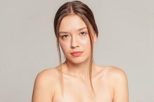 Beautiful Young Woman with Clean Fresh Skin touch own face photo