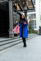 Beautiful young fashion woman with shopping bags photo