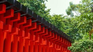 Ornaments on the Sam Poo Kong Pagoda in Semarang, a building lined with red pillars and black lines interspersed with reflections of sunlight.no people photo