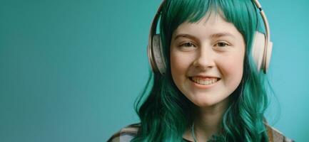 Gen Z teenager with green hair listens music in headphones. Music subscription service concept. photo
