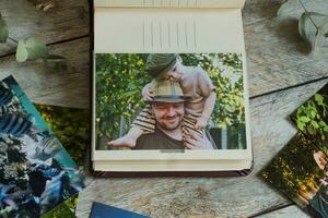 Printed photos in family picture album. Photo printing concept.