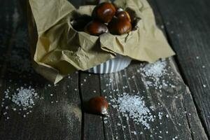 Chestnut on wooden background photo