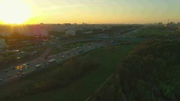 Flying around highway with cars traffic in the city at sunny evening. video