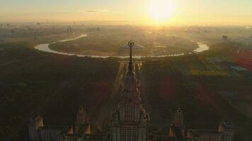 Flying around moscow state university in the sunny morning. City in sunrise fog. Aerial view. video