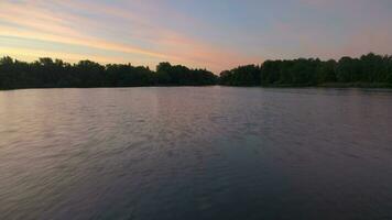 Fast low angle flying over the lake in sunny morning. Aerial view. video