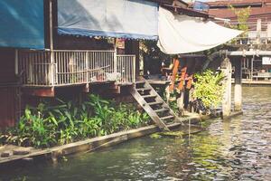 Wooden houses along the canals river, Thailand photo