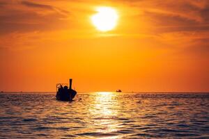 Fishing boat with sunset in phi phi islands Thailand photo