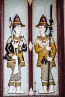 Thai style molding art on the door at Wat Phra Kaew temple, Thailand. photo