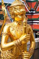 Golden Angle at Wat Phra Kaeo, Temple of the Emerald Buddha and the home of the Thai King. Wat Phra Kaeo is one of Bangkok's most famous tourist sites and it was built in 1782 at Bangkok, Thailand. photo