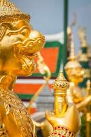 Golden Angle at Wat Phra Kaeo, Temple of the Emerald Buddha and the home of the Thai King. Wat Phra Kaeo is one of Bangkok's most famous tourist sites and it was built in 1782 at Bangkok, Thailand. photo