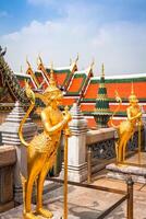 Golden Angle at Wat Phra Kaeo, Temple of the Emerald Buddha and the home of the Thai King. Wat Phra Kaeo is one of Bangkok's most famous tourist sites and it was built in 1782 at Bangkok, Thailand. photo