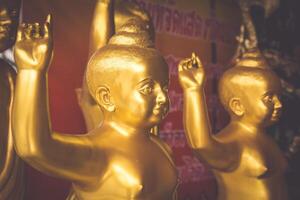 Golden Buddha statue in the Wat Intharawihan at Bangkok, Thailand photo