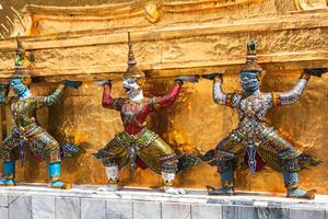 Guards on the base level of stupa in Wat Phra Keo, Thailand photo