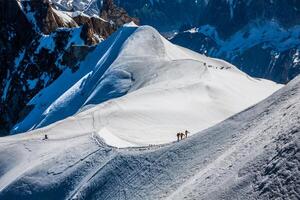 Mont Blanc, Chamonix, French Alps. France. - tourists climbing up the mountain photo