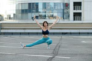 Strong young woman stretching with skipping. photo