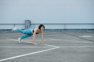 Young muscular woman doing core exercise. photo