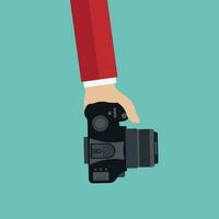 Hand hold camera with shadow, flat design, vector