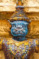 Guards on the base level of stupa in Wat Phra Keo, Thailand photo