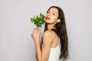 Beautiful smiling girl with parsley. Healthy lifestyle concept photo