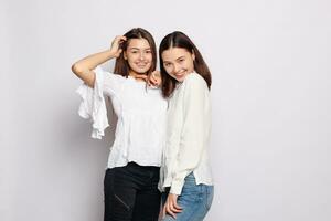 two laughing girls in white blank t-shirts looking into the camera photo